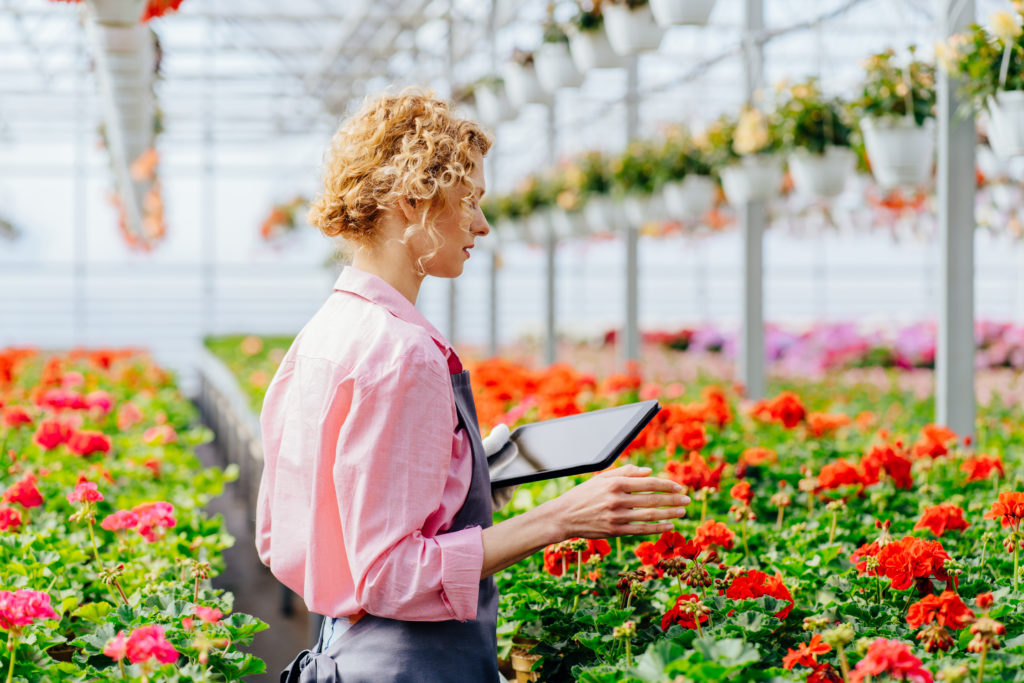 Female worker supervising plants production